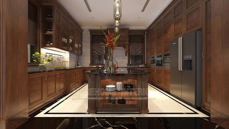 Thiết kế tủ bếp gỗ óc chó tân cổ điển tại Hà Nội kết hợp bàn đảo vừa mang lại độ bền cao, vừa biến một phần nhà bếp thành quầy bar hay bàn ăn phụ thuận tiện Tủ bếp biệt thự